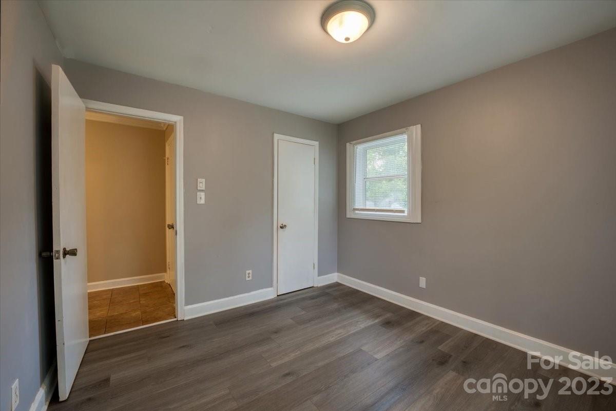 1223 Ranch Road Charlotte, NC 28208 - Photo 23 of 34 an empty room with wooden floor and windows