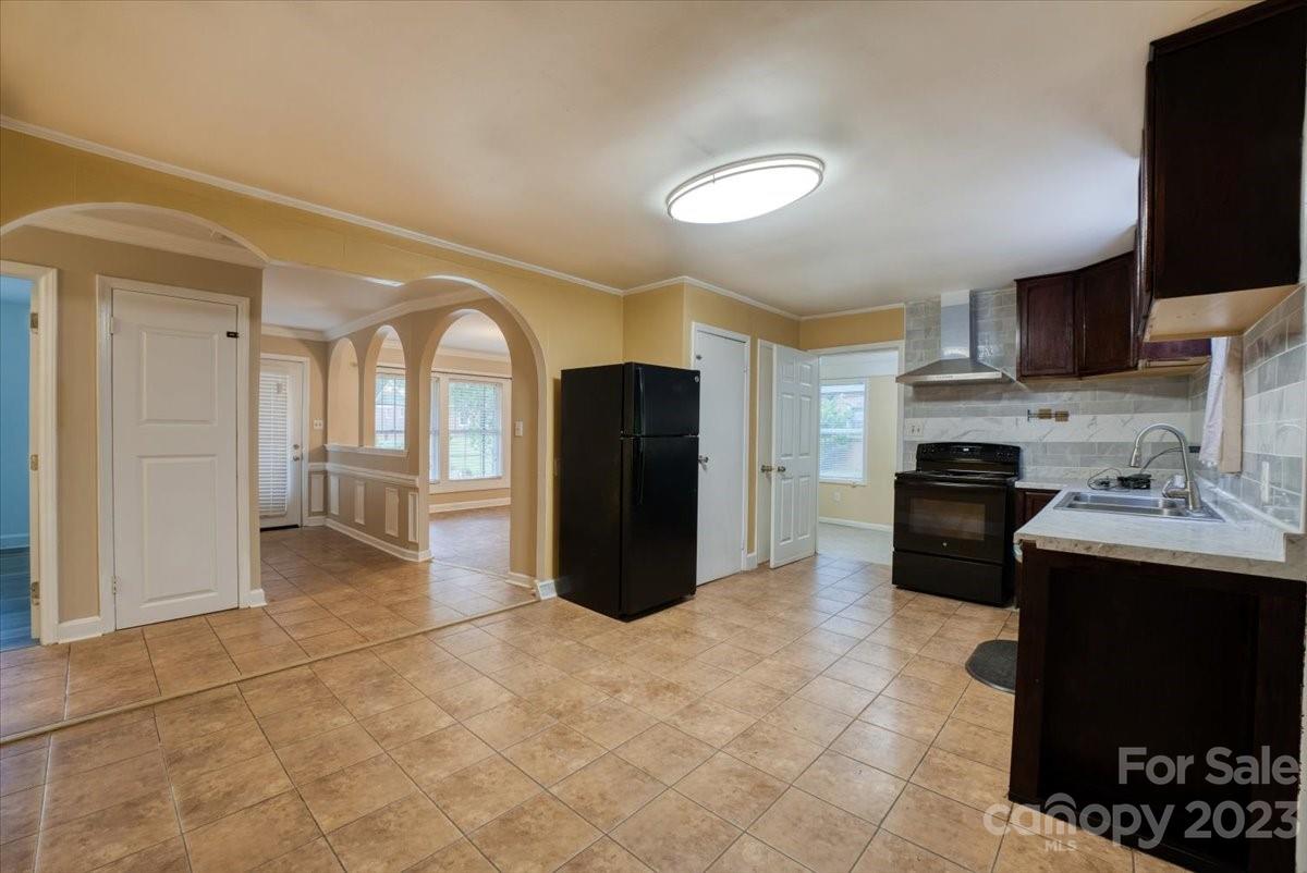 1223 Ranch Road Charlotte, NC 28208 - Photo 6 of 34 a kitchen with a refrigerator and a stove top oven
