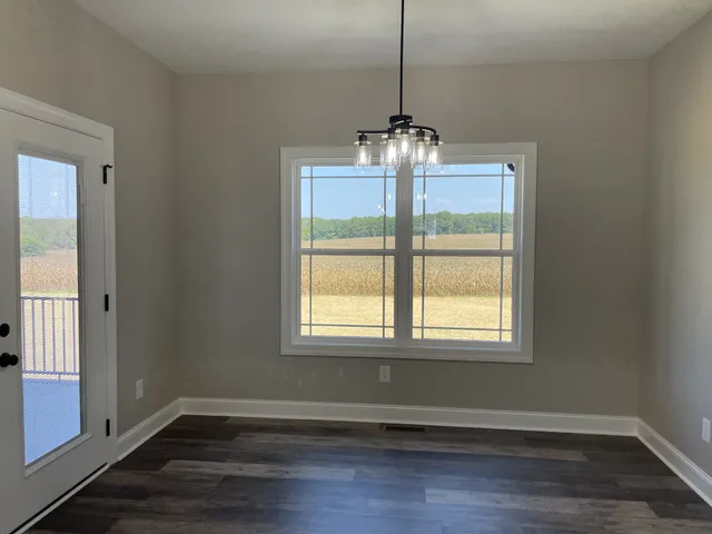 a large room with a large window and stainless steel appliances