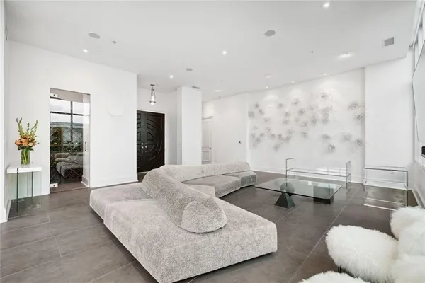 a dining hall with stainless steel appliances kitchen island granite countertop a sink and refrigerator
