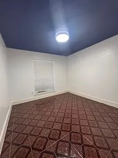 a view of a room with wooden floor