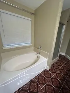 a bath tub sitting next to a white sink