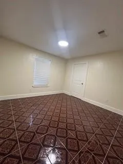 a view of a room with wooden floor and windows