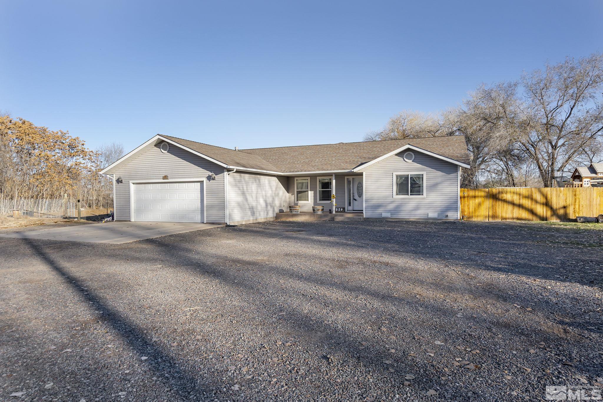 529 McLean Road Fallon, NV 89406 - Photo 2 of 19 a view of a house with a yard and a garage
