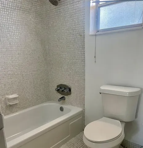 a bathroom with a sink mirror and toilet