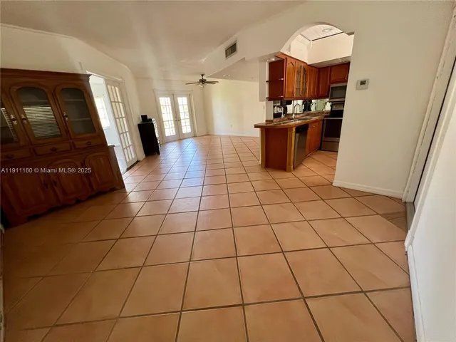 a kitchen with stainless steel appliances granite countertop a sink and cabinets
