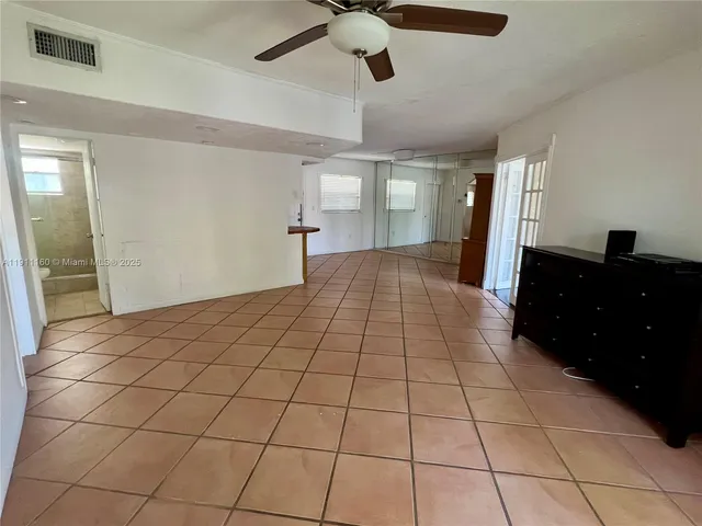 a view of an empty room and a window