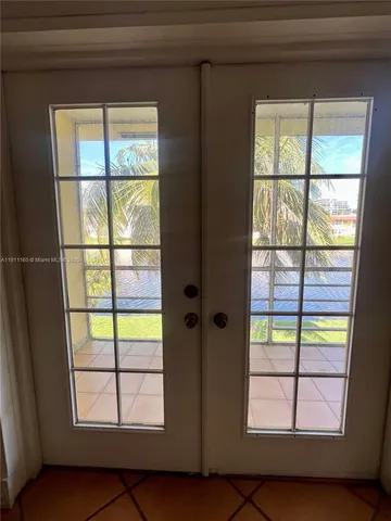 a kitchen with granite countertop a refrigerator and a stove top oven