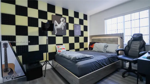 a bedroom with a bed and a window