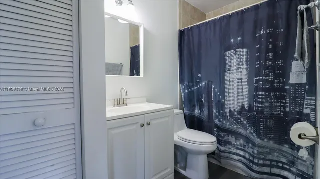 a bathroom with a toilet a sink and shower