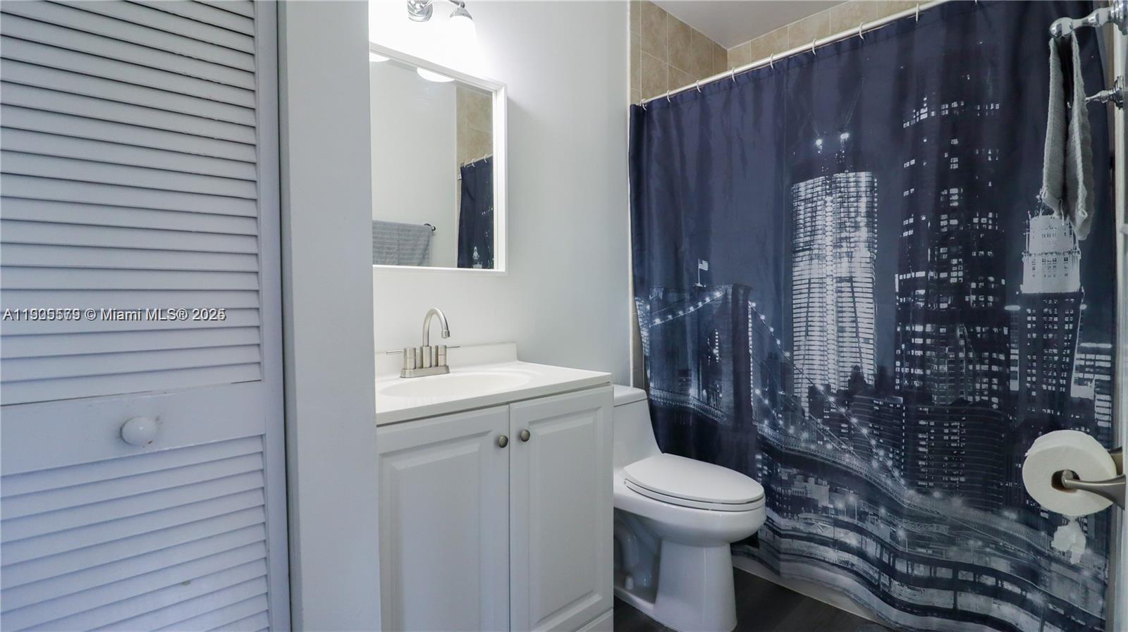 15330 Southwest 134th Place, Unit 308 Miami, FL 33177 - Photo 13 of 29 a bathroom with a toilet a sink and shower