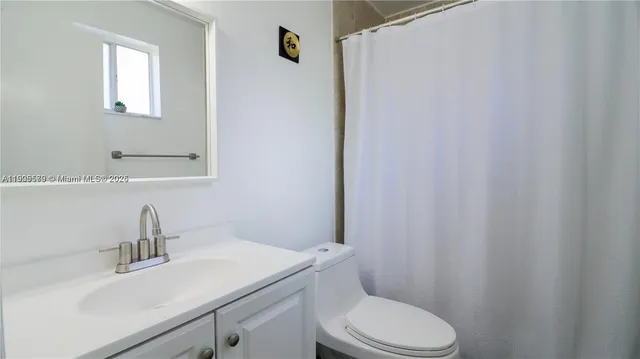 a bathroom with a sink a toilet and vanity