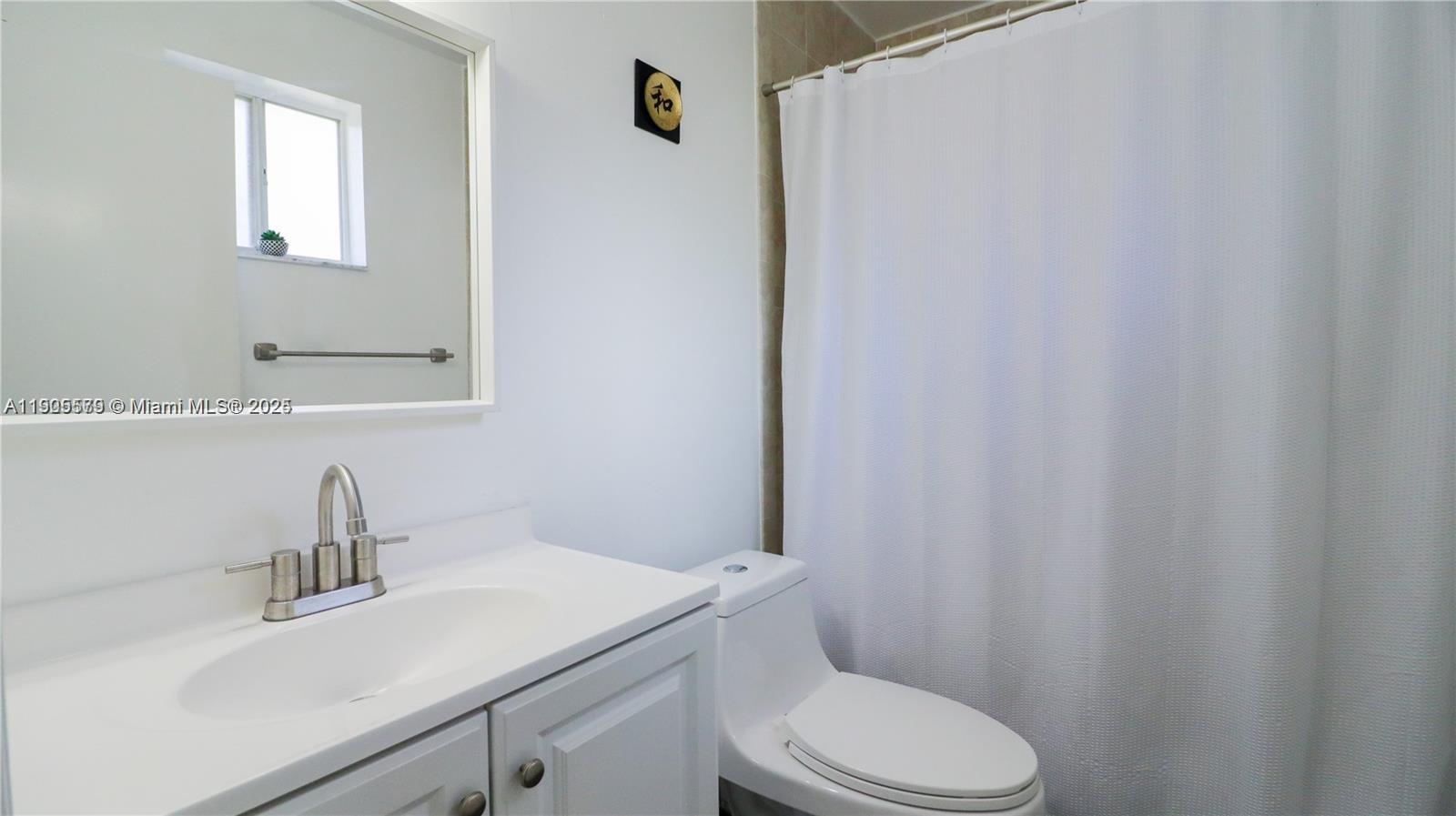 15330 Southwest 134th Place, Unit 308 Miami, FL 33177 - Photo 15 of 29 a bathroom with a sink a toilet and vanity