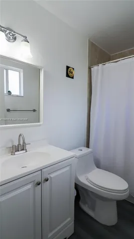 a white toilet sitting next to a bathroom sink