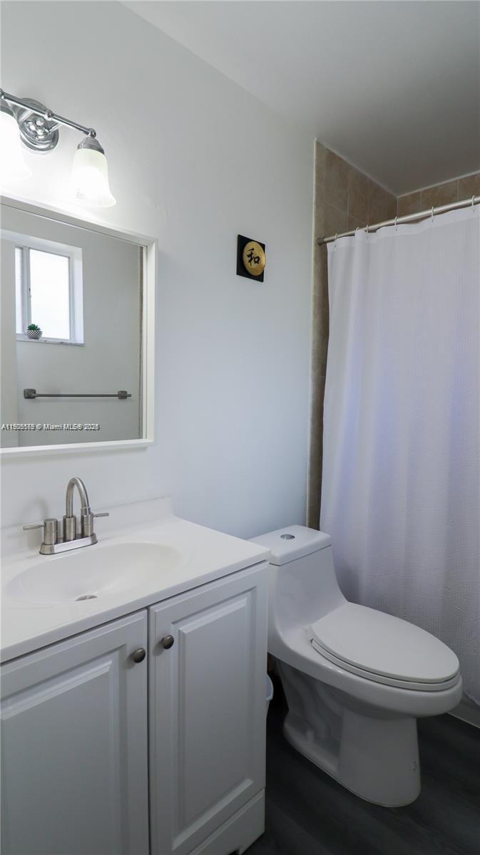 15330 Southwest 134th Place, Unit 308 Miami, FL 33177 - Photo 18 of 29 a white toilet sitting next to a bathroom sink
