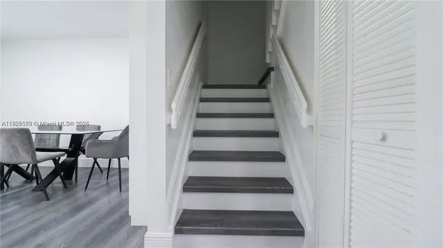 a view of entryway and hall with wooden floor