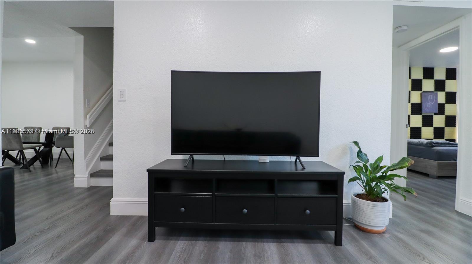 15330 Southwest 134th Place, Unit 308 Miami, FL 33177 - Photo 23 of 29 a living room with furniture and a flat screen tv