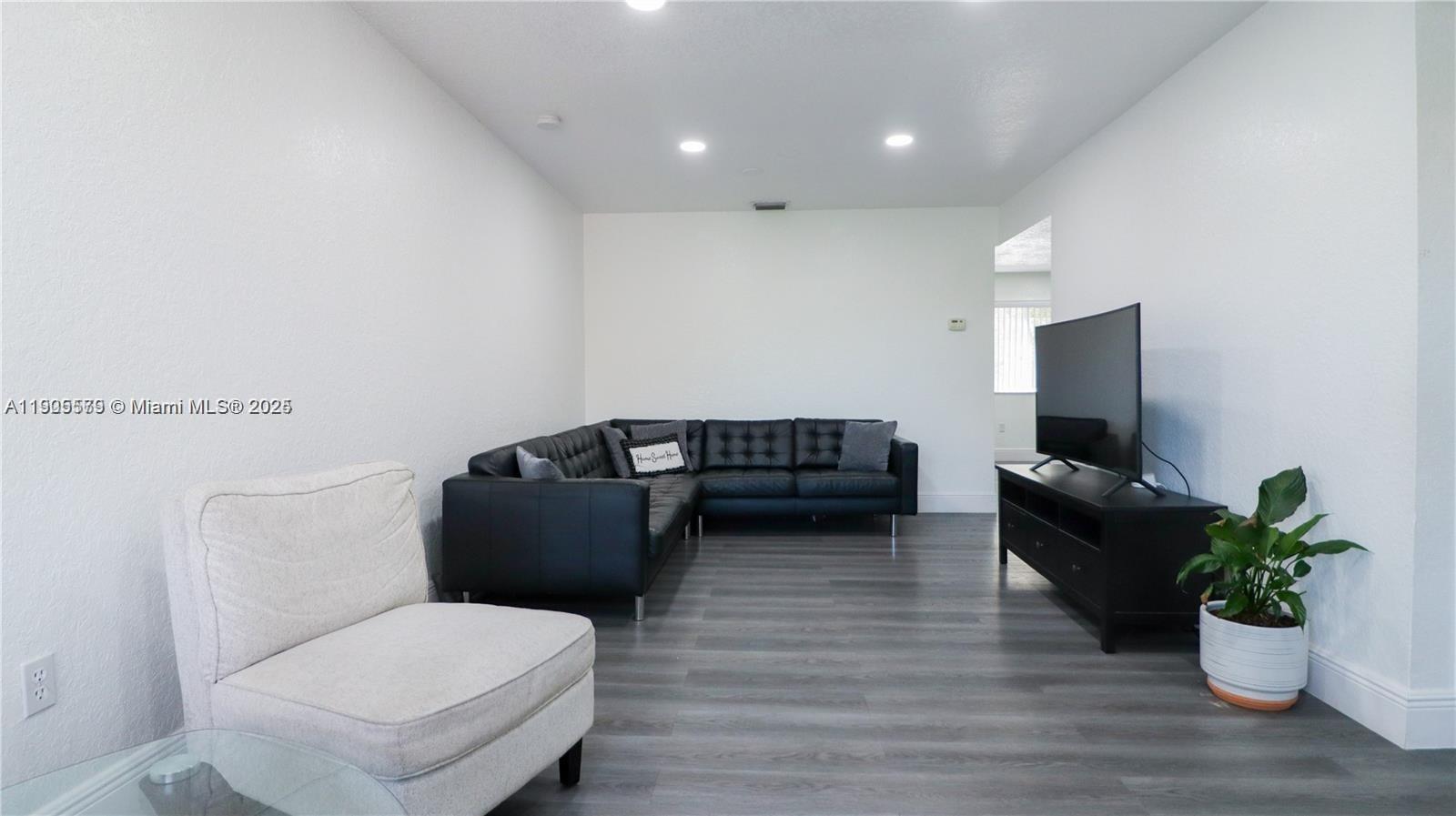15330 Southwest 134th Place, Unit 308 Miami, FL 33177 - Photo 5 of 29 a living room with furniture and a potted plant