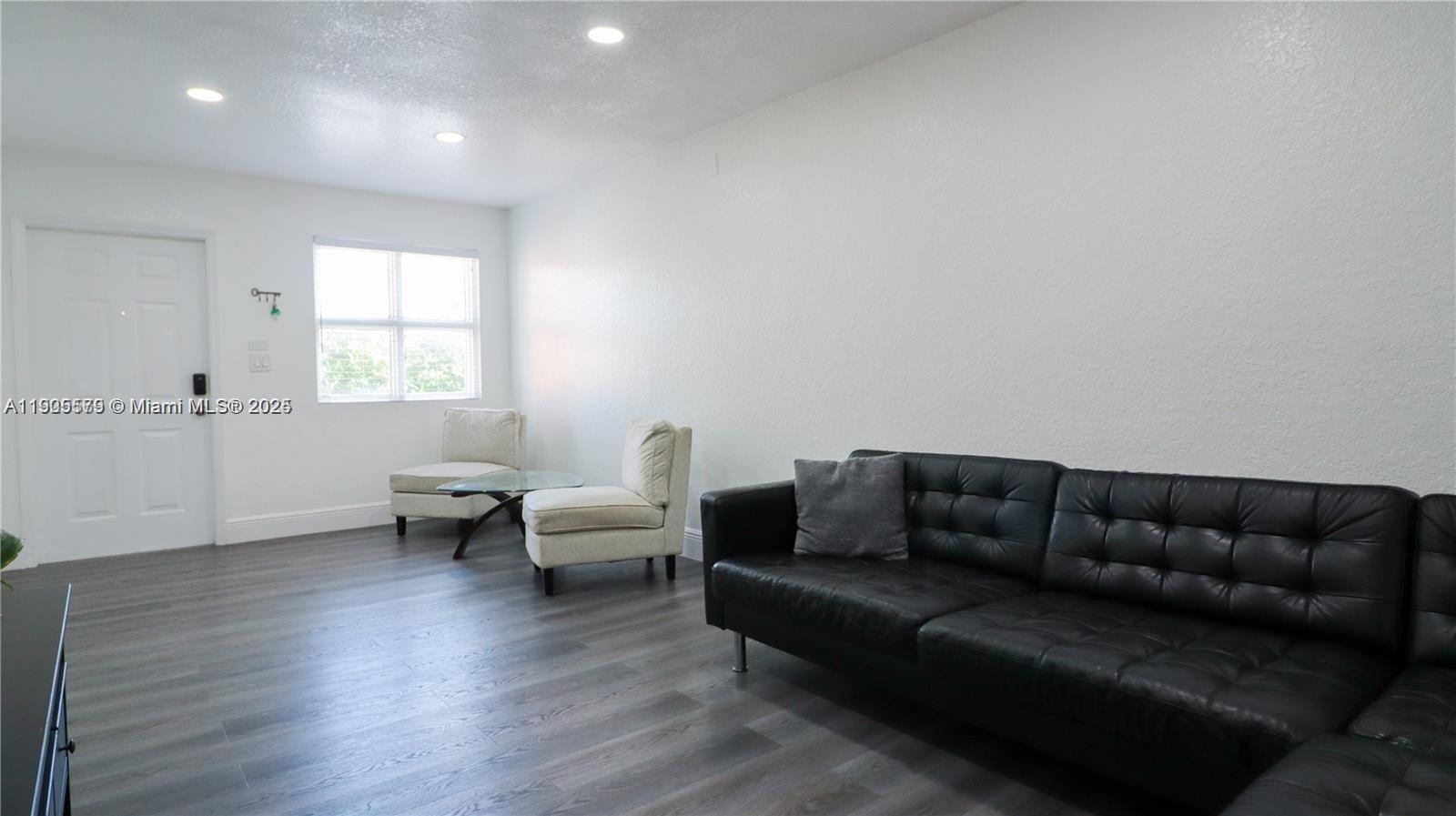 15330 Southwest 134th Place, Unit 308 Miami, FL 33177 - Photo 7 of 29 a living room with furniture and wooden floor