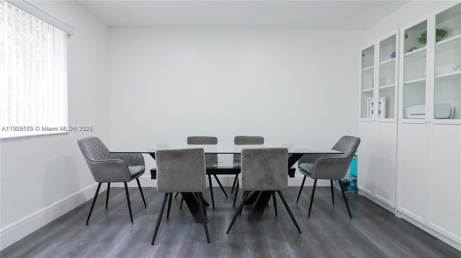 15330 Southwest 134th Place, Unit 308 Miami, FL 33177 - Photo 8 of 29 a view of a dining room with furniture and wooden floor