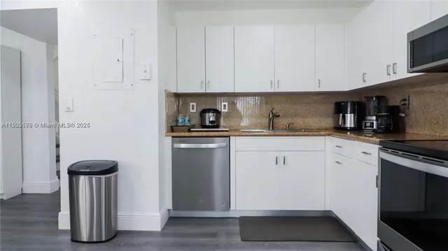 a kitchen with cabinets and appliances