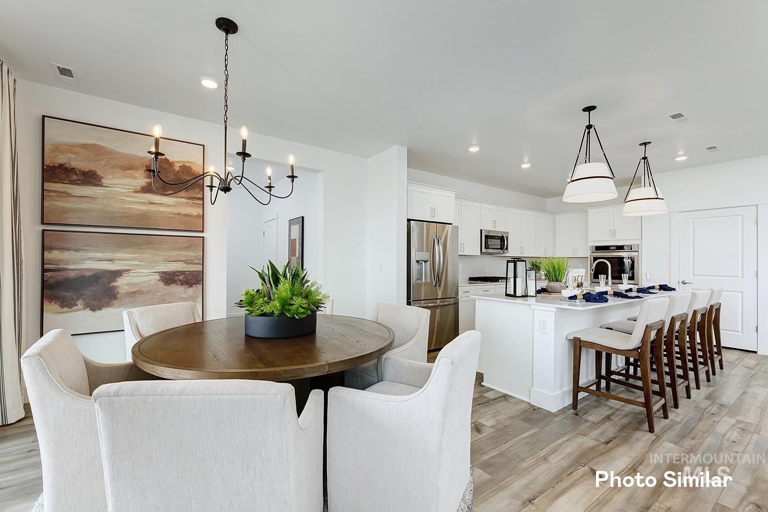 3993 North Creswell Street Boise, ID 83713 - Photo 10 of 34 Dining room with light wood-style floors, recessed lighting, and a chandelier
