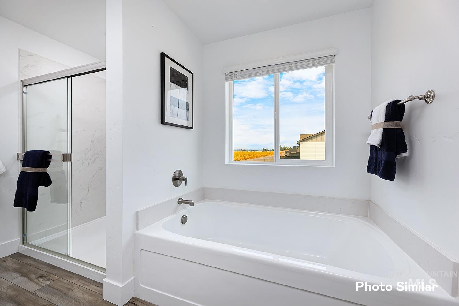 3993 North Creswell Street Boise, ID 83713 - Photo 28 of 34 Bathroom with a bath, a marble finish shower, and wood finished floors