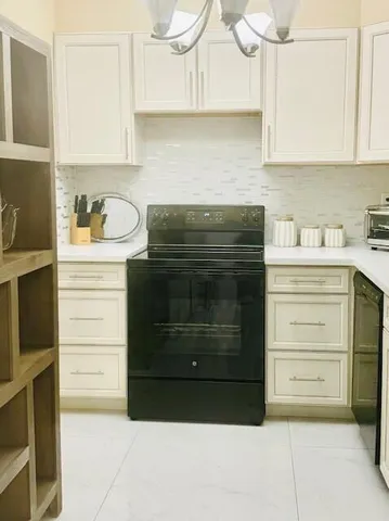 a large bed sitting in a bedroom next to a cabinet