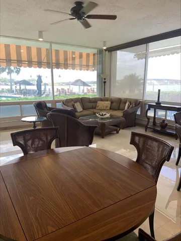 a balcony with table and chairs