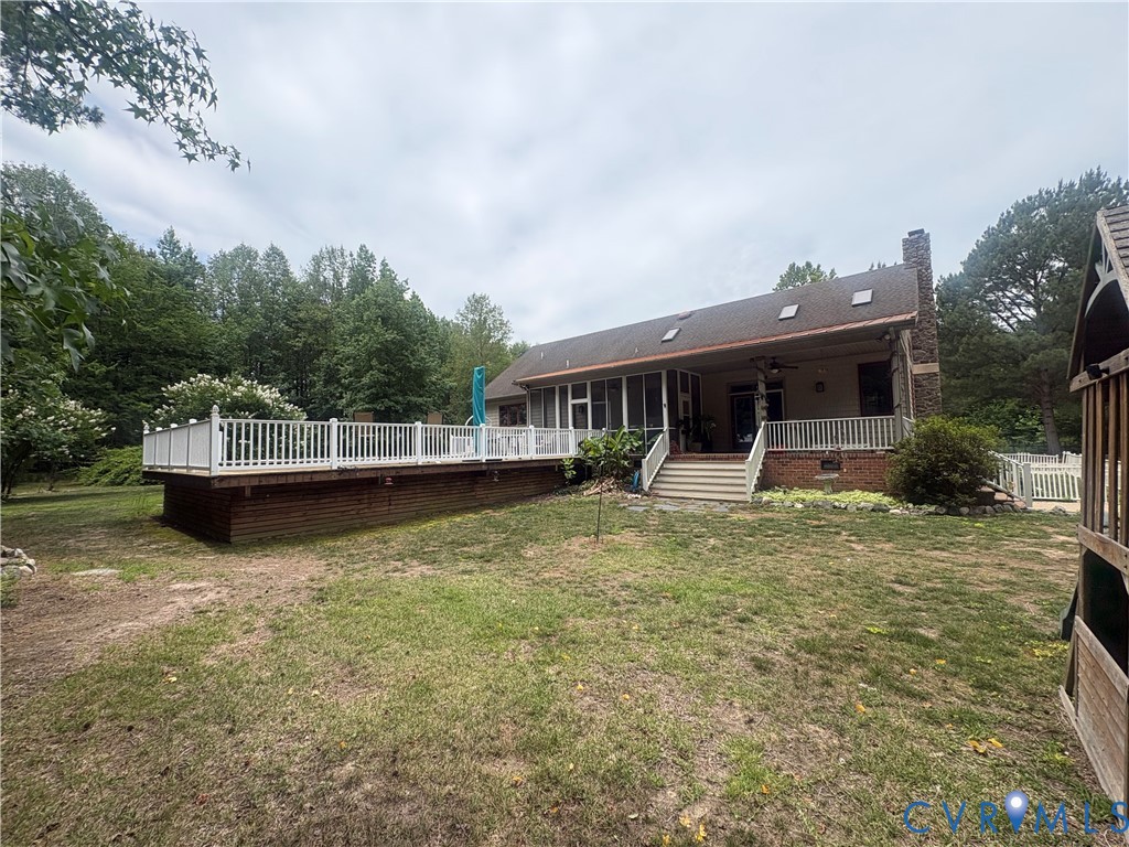 4215 Newville Road Waverly, VA 23890 - Photo 3 of 5 Expansive rear deck with white railings and brick