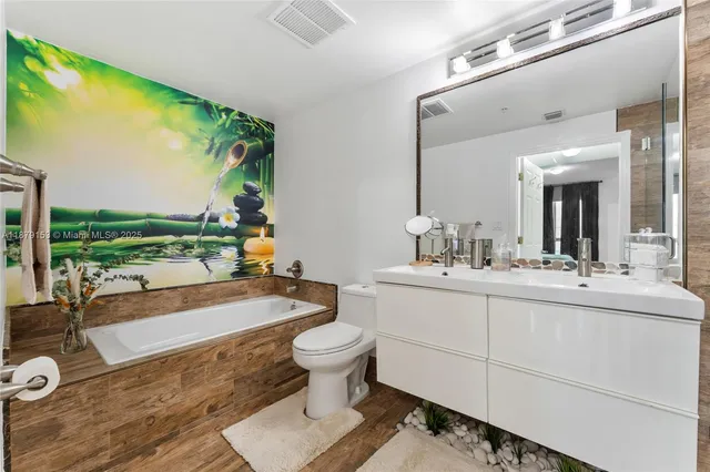 a bathroom with a sink mirror and shower