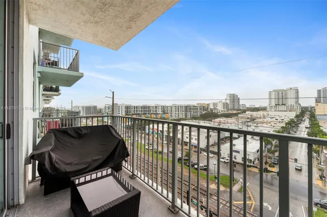 a view of a balcony with chair and wooden floor