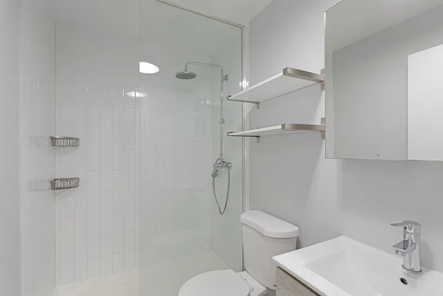 a bathroom with a toilet a sink and shower