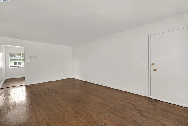 a view of an empty room and wooden floor