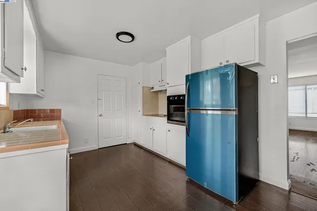 a kitchen with refrigerator and window