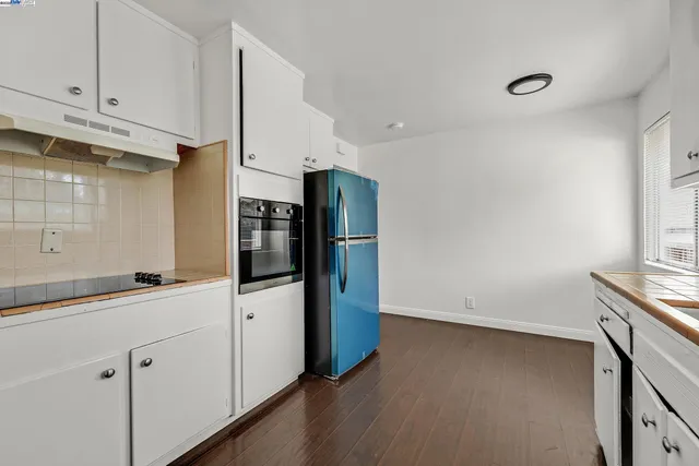 a kitchen with stainless steel appliances a refrigerator and cabinets