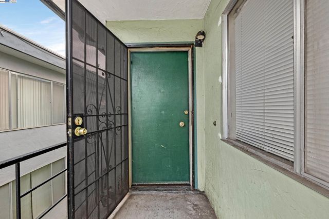 a view of an empty room and wooden floor