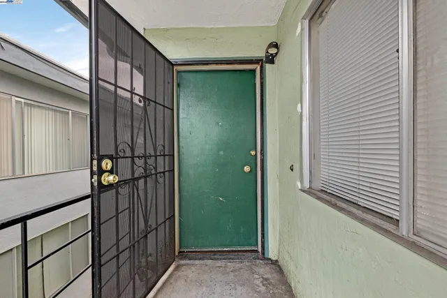 a view of an empty room and wooden floor