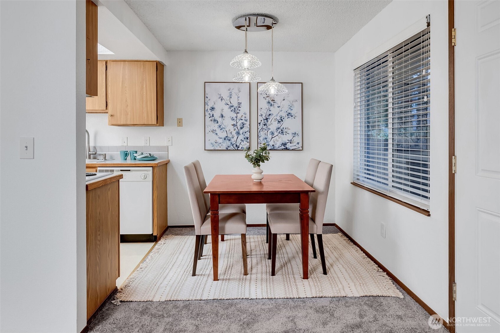 7520 208th Street Southwest, Unit A101 Edmonds, WA 98026 - Photo 12 of 27 a view of a dining room with furniture and wooden floor