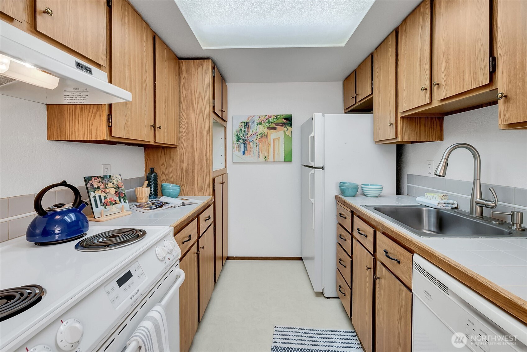 7520 208th Street Southwest, Unit A101 Edmonds, WA 98026 - Photo 15 of 27 a kitchen with sink a stove and cabinets