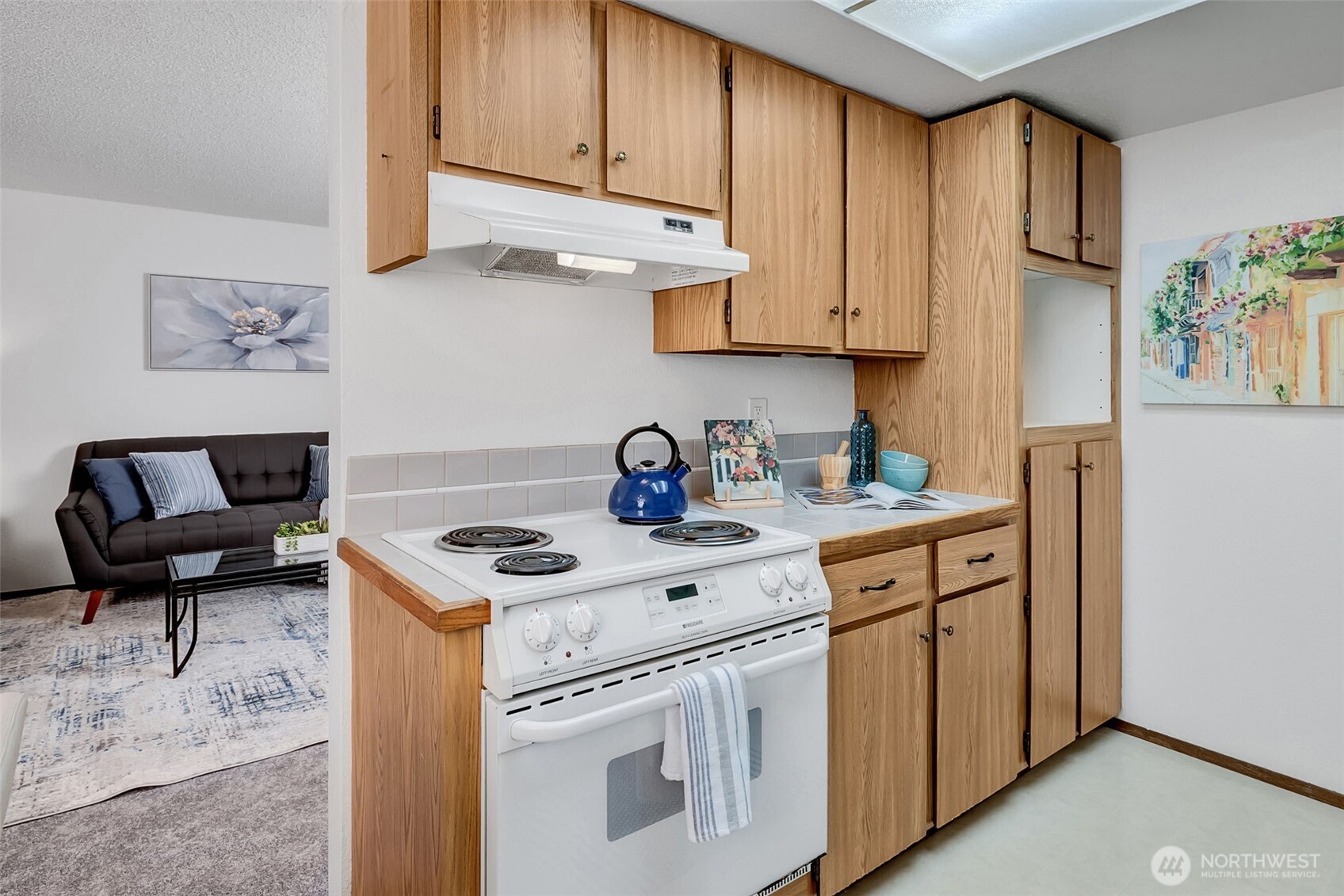 7520 208th Street Southwest, Unit A101 Edmonds, WA 98026 - Photo 16 of 27 a kitchen with stainless steel appliances granite countertop a sink stove and cabinets