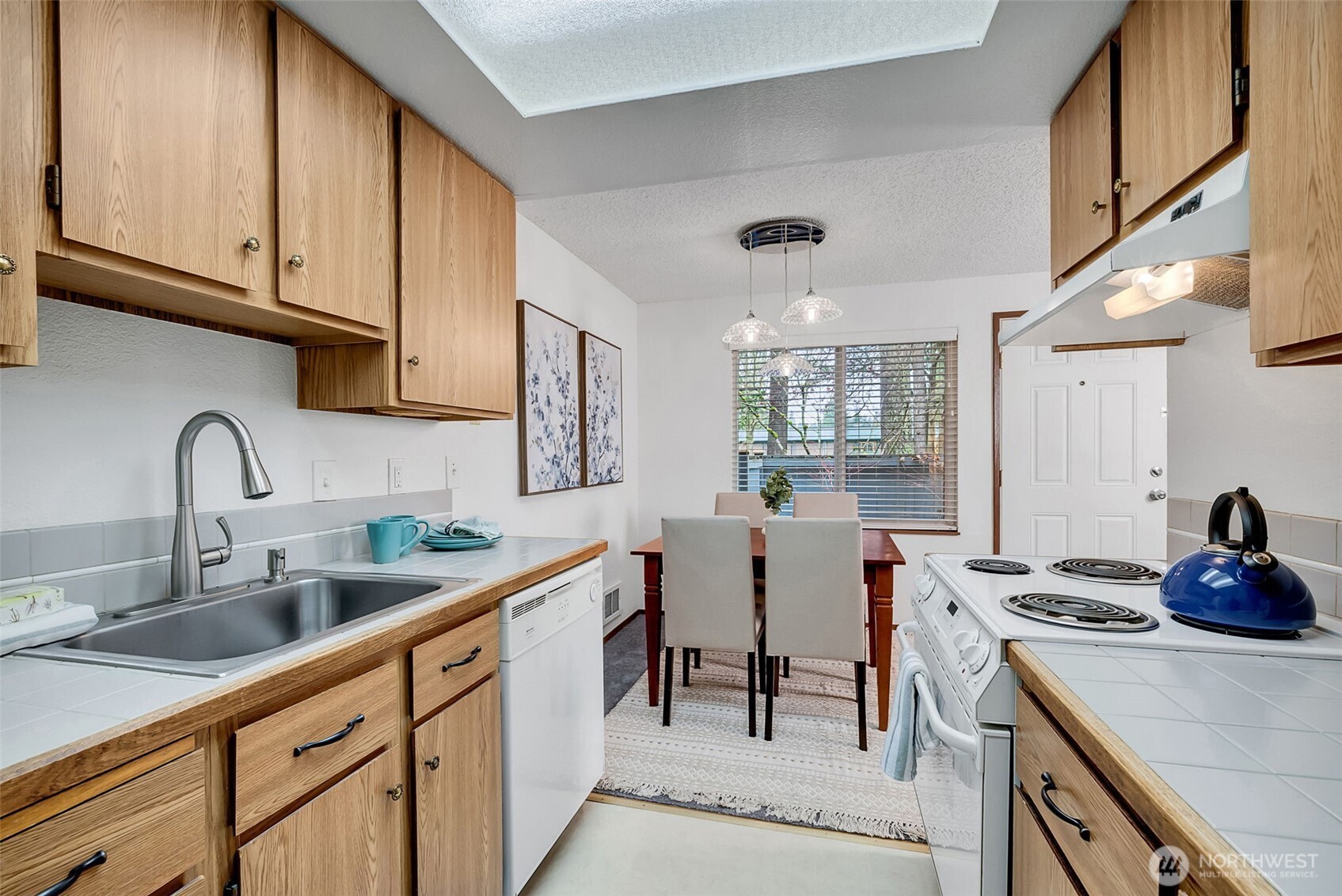 7520 208th Street Southwest, Unit A101 Edmonds, WA 98026 - Photo 18 of 27 a kitchen with stainless steel appliances granite countertop a sink stove and cabinets