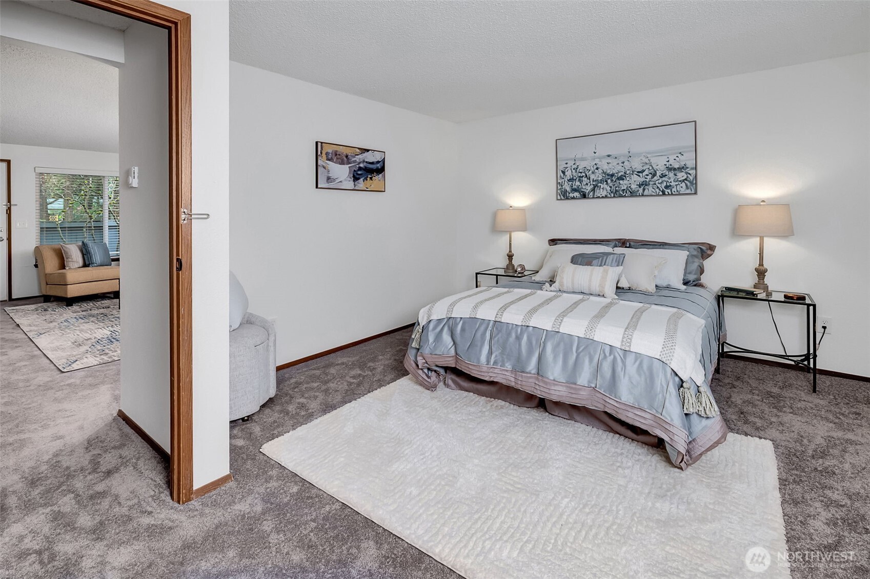 7520 208th Street Southwest, Unit A101 Edmonds, WA 98026 - Photo 20 of 27 a bedroom with a bed and a view of bathroom