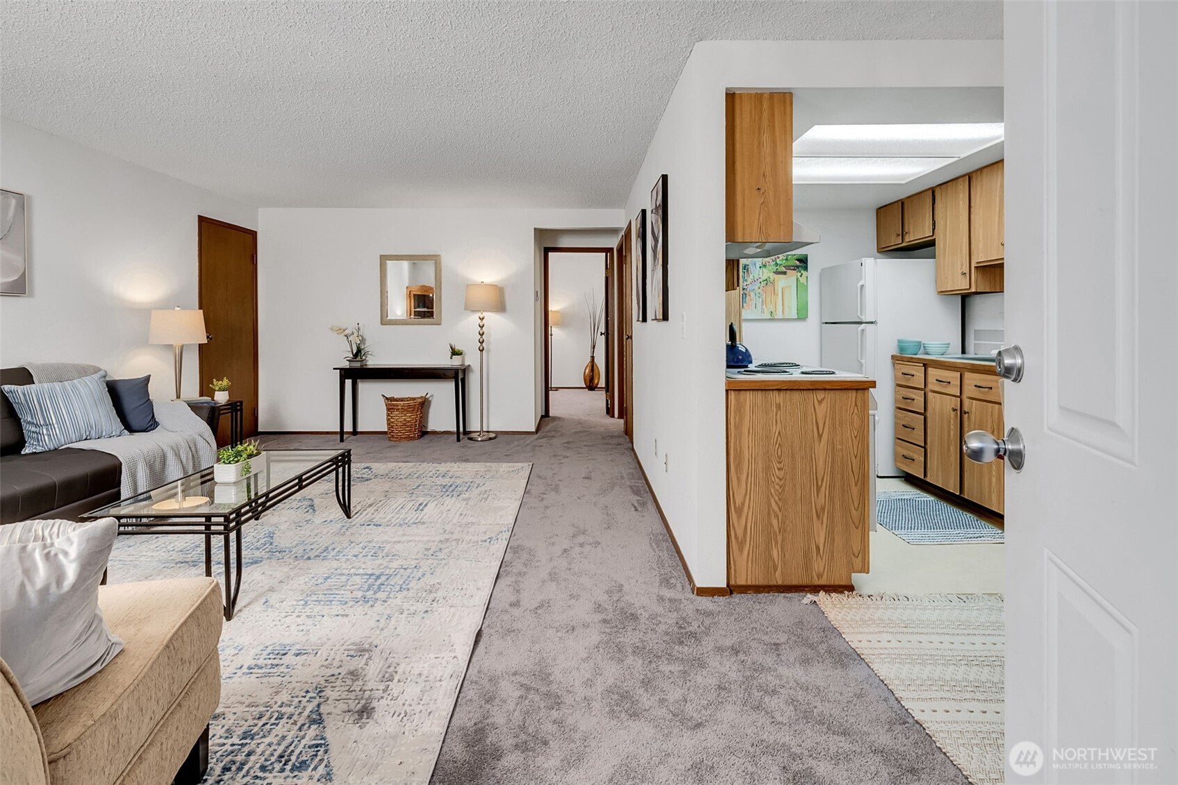7520 208th Street Southwest, Unit A101 Edmonds, WA 98026 - Photo 5 of 27 a living room with furniture and a wooden floor