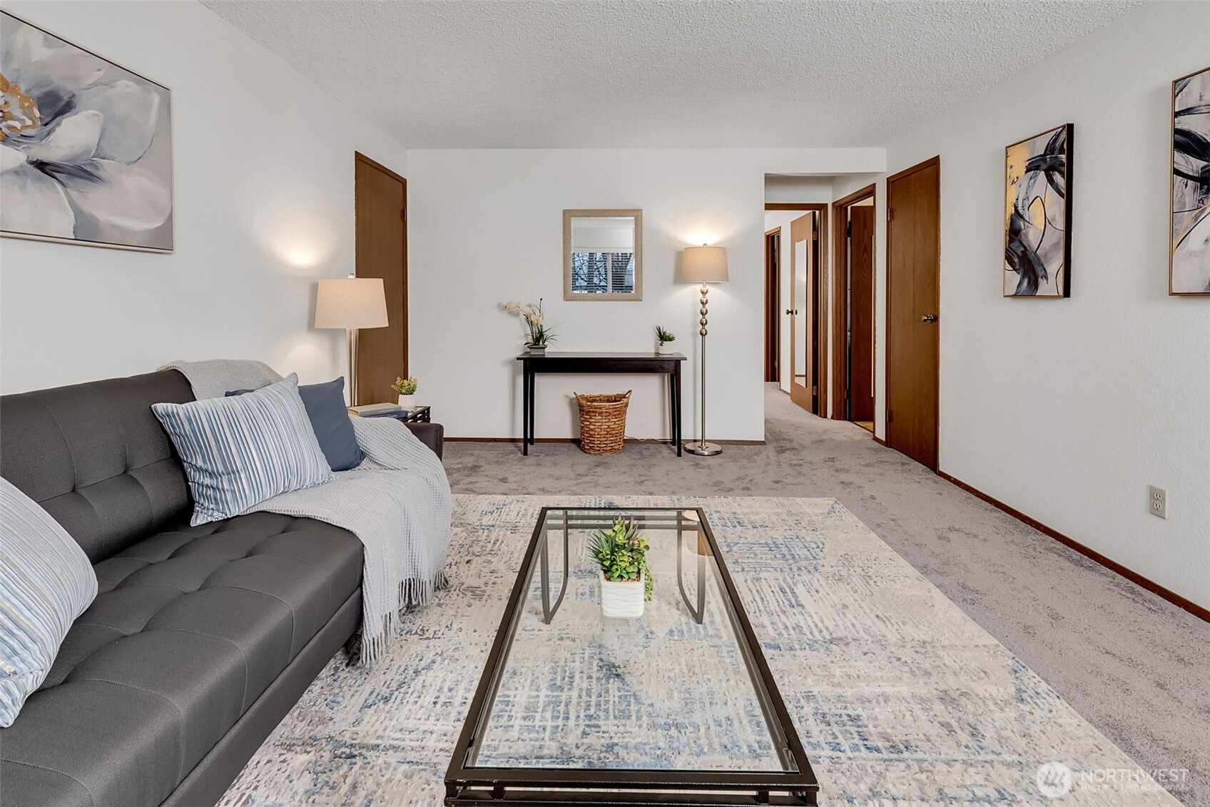 7520 208th Street Southwest, Unit A101 Edmonds, WA 98026 - Photo 8 of 27 a living room with furniture and a table