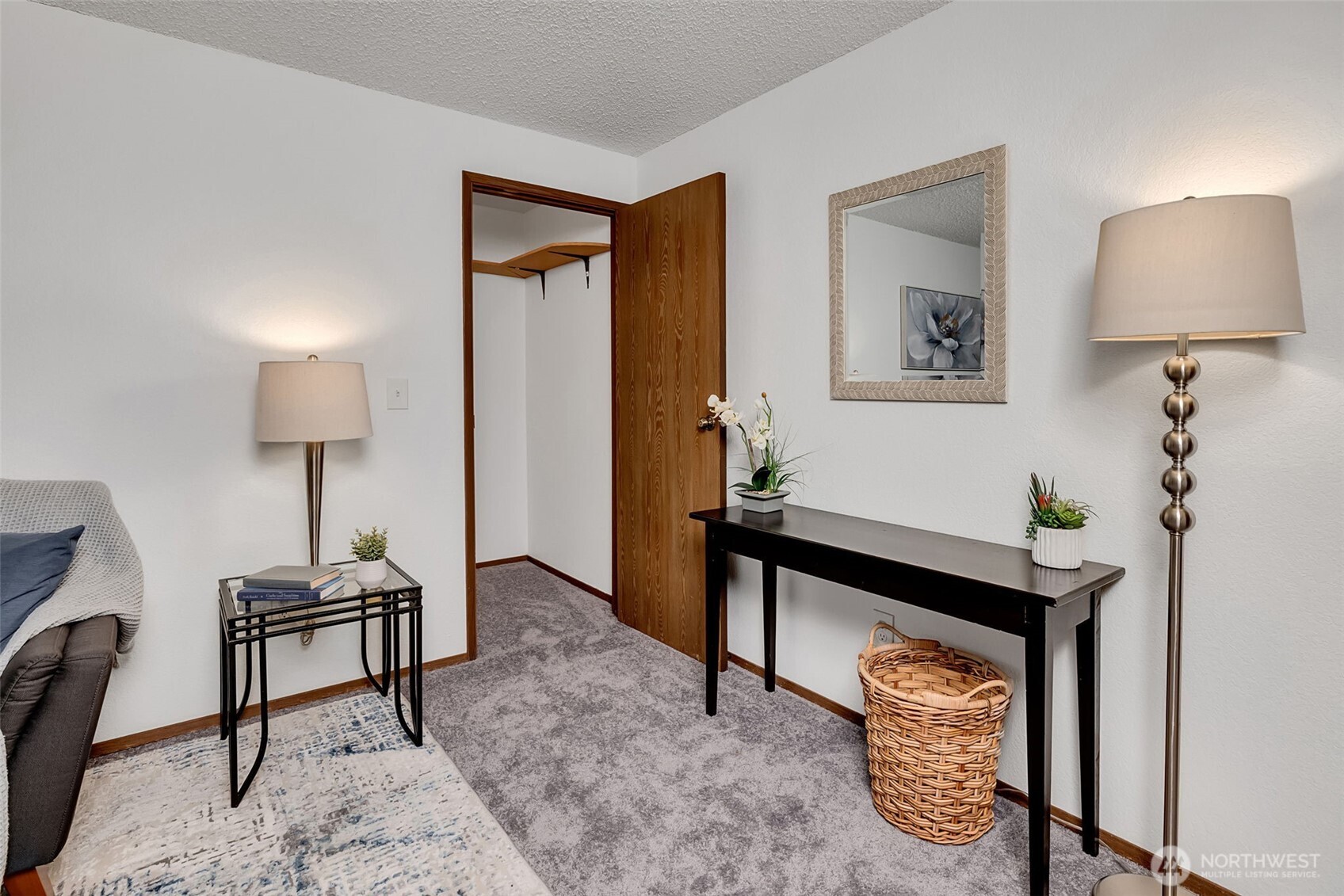 7520 208th Street Southwest, Unit A101 Edmonds, WA 98026 - Photo 9 of 27 a bedroom with a bed and a lamp on table