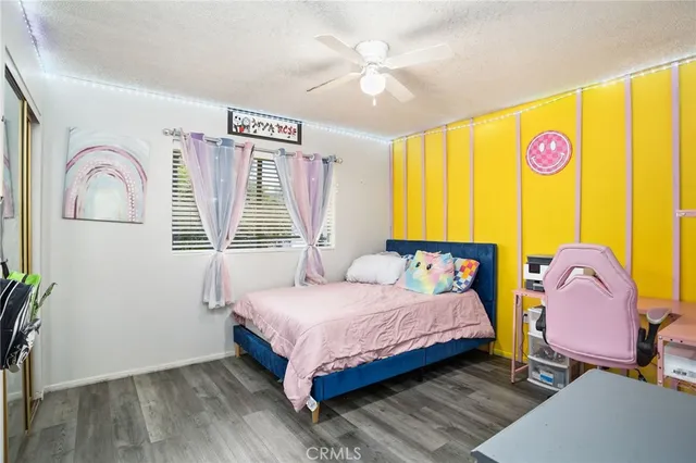 a bedroom with a bed dresser and a window