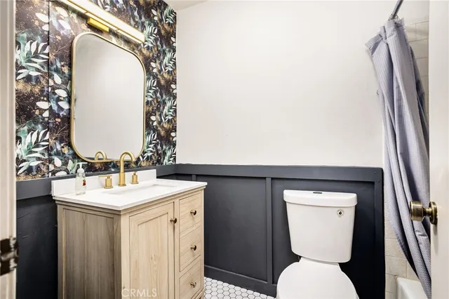 a bathroom with a sink toilet and mirror