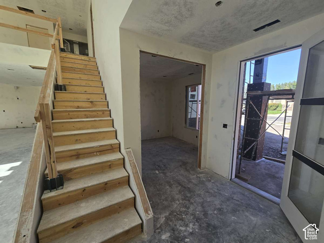 338 West 3400 South Logan, UT 84321 - Photo 23 of 40 Open entry featuring a wood staircase with a wood railing
