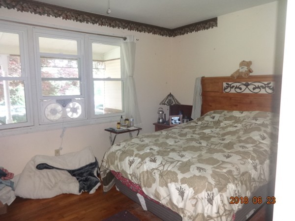 547 North Avenue Rochester, MA 02770 - Photo 13 of 26 a bed sitting in a bedroom next to a window